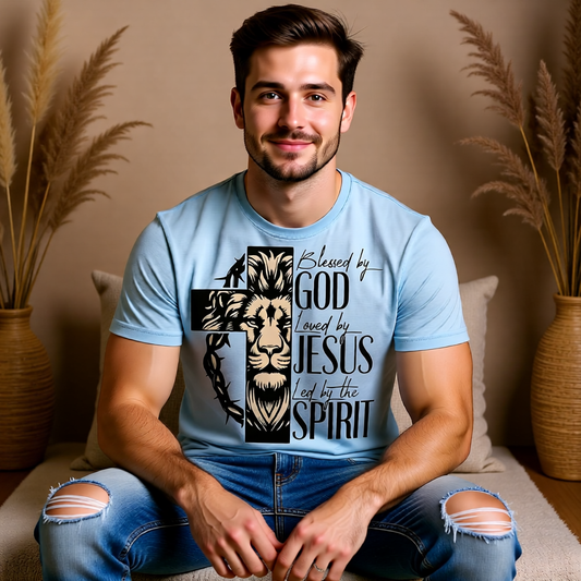 Man wearing a light blue t-shirt with a graphic design sitting on a couch.