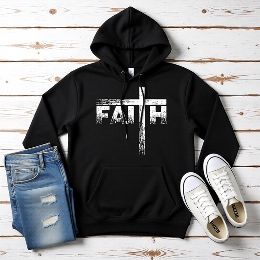 Black hoodie with 'FAITH' text, blue jeans, and white sneakers on a wooden surface